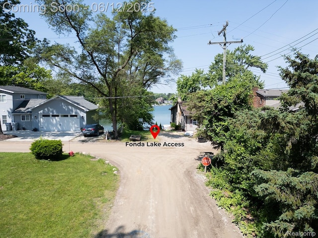 6287 Woodring Ct, Brighton, MI 48116 - view of dirt / gravel road with traffic signs