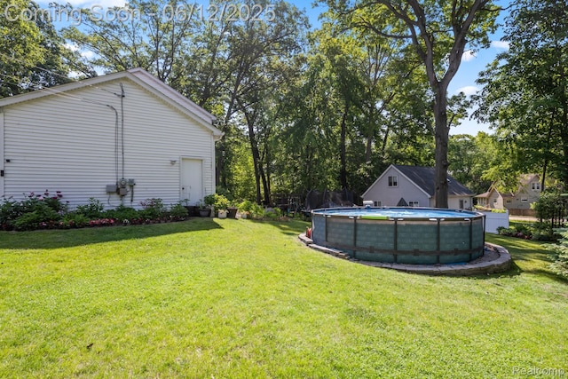 6287 Woodring Ct, Brighton, MI 48116 - view of grassy yard featuring an outdoor pool