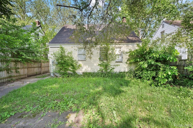 7784 Mettetal St, Detroit, MI 48228 - view of property exterior with a shingled roof and a chimney