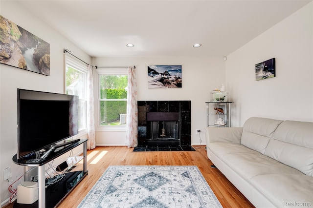 39719 Squire Rd, Novi, MI 48375 - living area featuring wood finished floors, a tiled fireplace, recessed lighting, and baseboards