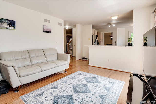 39719 Squire Rd, Novi, MI 48375 - living room featuring stairs and light wood finished floors