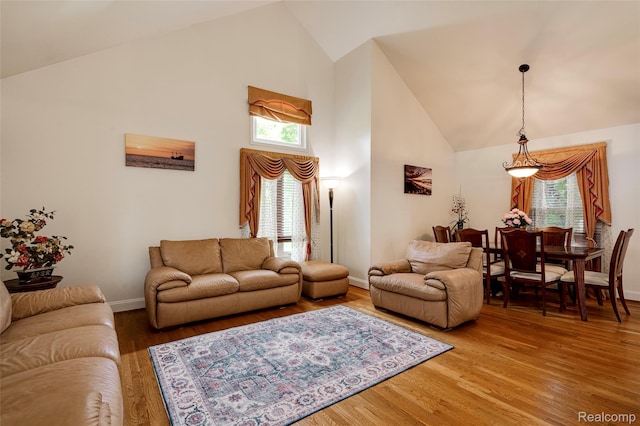 39719 Squire Rd, Novi, MI 48375 - living room featuring high vaulted ceiling, light wood-type flooring, and baseboards