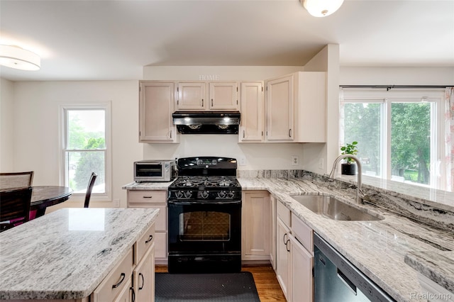 39719 Squire Rd, Novi, MI 48375 - kitchen featuring black range with gas cooktop, under cabinet range hood, a sink, stainless steel dishwasher, and plenty of natural light
