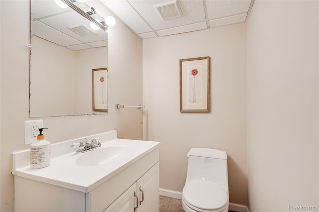 39719 Squire Rd, Novi, MI 48375 - bathroom with vanity, toilet, baseboards, and a paneled ceiling