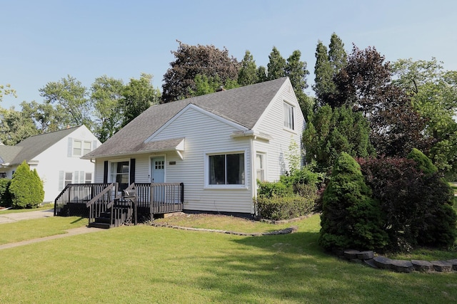 600 Center Dr, Tecumseh, MI 49286 - view of front of house with a front lawn, a deck, and a shingled roof