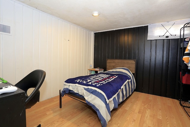 600 Center Dr, Tecumseh, MI 49286 - bedroom featuring wood finished floors and wooden walls