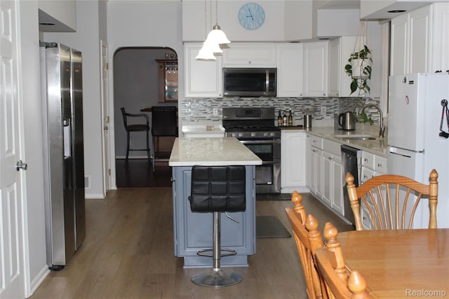 300 Crestway Ct, Saline, MI 48176 - kitchen featuring stainless steel appliances, dark wood-type flooring, backsplash, and white cabinetry