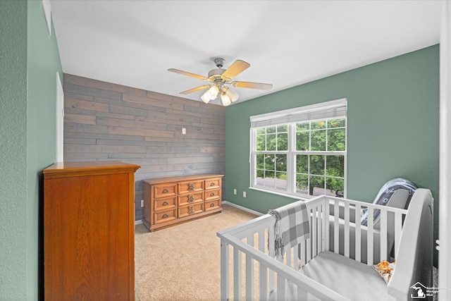 773 Hunting Creek Rd, Temperance, MI 48182 - bedroom with carpet floors, an accent wall, wooden walls, a ceiling fan, and baseboards