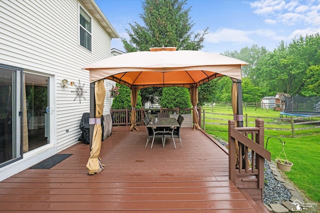 773 Hunting Creek Rd, Temperance, MI 48182 - deck featuring a trampoline, outdoor dining space, a gazebo, and a yard
