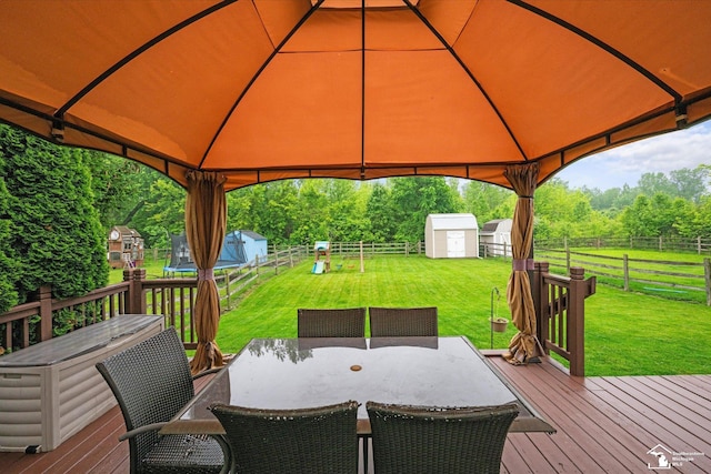773 Hunting Creek Rd, Temperance, MI 48182 - deck with a gazebo, outdoor dining area, a trampoline, and a playground