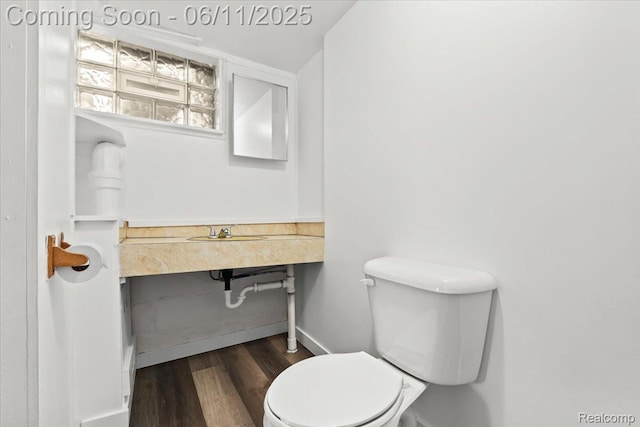 4469 5th St, Ecorse, MI 48229 - bathroom with wood finished floors, toilet, and baseboards