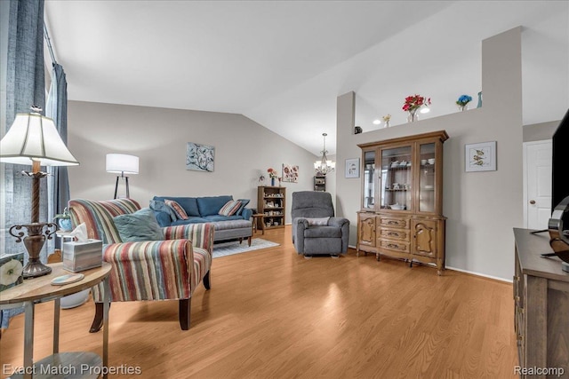 140 Pine Tree Ridge Dr Unit 2, Waterford, MI 48327 - living room featuring vaulted ceiling, a chandelier, and light wood-style floors