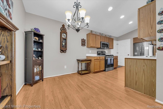 140 Pine Tree Ridge Dr Unit 2, Waterford, MI 48327 - kitchen with appliances with stainless steel finishes, light wood-style floors, lofted ceiling, light countertops, and a chandelier