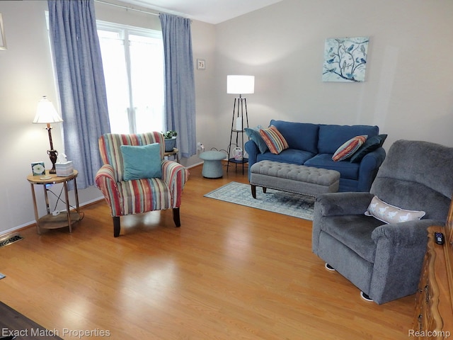 140 Pine Tree Ridge Dr Unit 2, Waterford, MI 48327 - living room with light wood-type flooring and baseboards