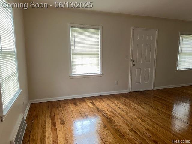 19628 Elkhart St, Harper Woods, MI 48225 - spare room featuring hardwood / wood-style floors and healthy amount of natural light