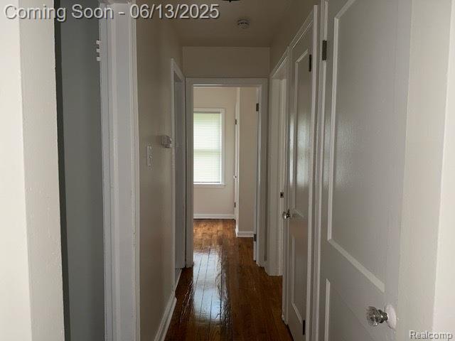 19628 Elkhart St, Harper Woods, MI 48225 - corridor featuring dark wood-style flooring and baseboards