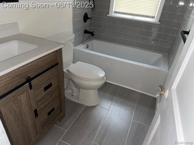 19628 Elkhart St, Harper Woods, MI 48225 - bathroom with toilet, vanity, washtub / shower combination, and wood finished floors