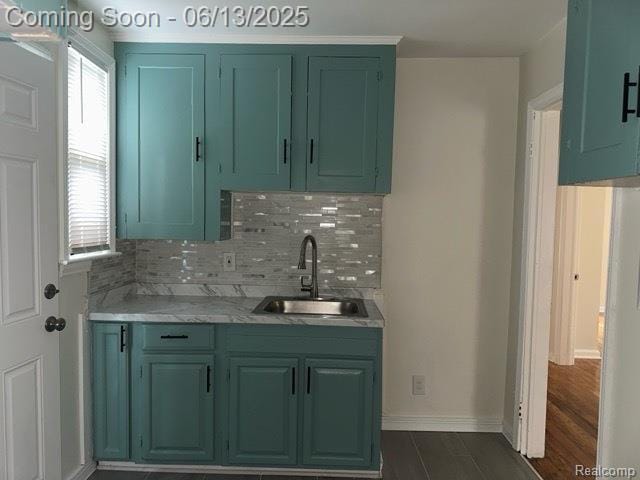 19628 Elkhart St, Harper Woods, MI 48225 - kitchen featuring a sink, light countertops, backsplash, and green cabinets