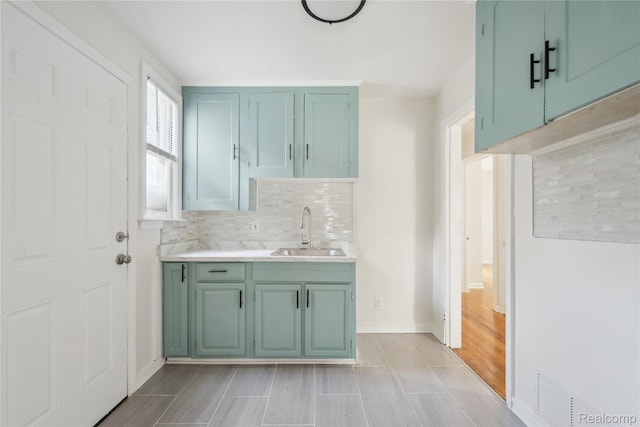 19628 Elkhart St, Harper Woods, MI 48225 - kitchen with backsplash, light countertops, and light wood-style floors