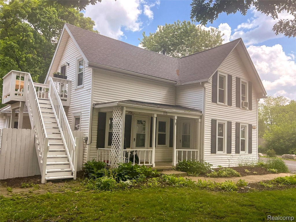 815 Rickett Rd, Brighton, MI 48116 - view of front facade with roof with shingles, stairway, covered porch, and a deck