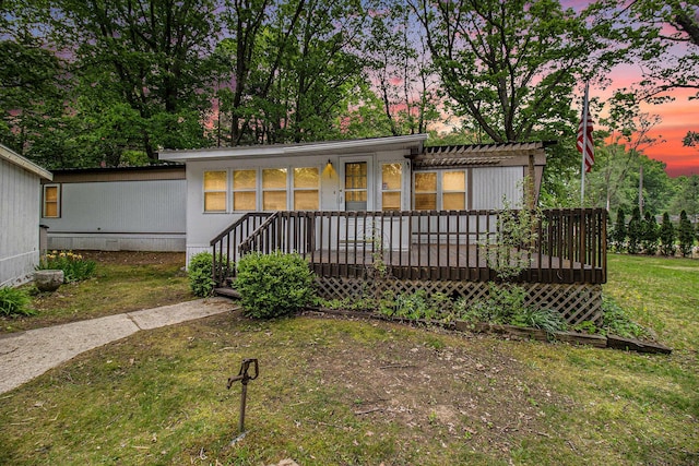 180 Bonnie St, Ludington, MI 49431 - view of front of house with a lawn, a pergola, and a wooden deck
