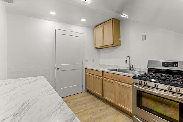 9213 Conant, Hamtramck, MI 48212 - kitchen featuring stainless steel gas range oven, a sink, light wood-style floors, recessed lighting, and light stone countertops
