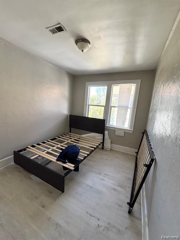 2340 Clements St, Detroit, MI 48238 - bedroom with baseboards and wood finished floors