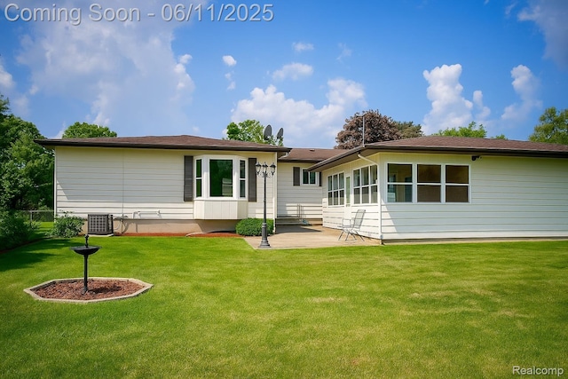 3161 Eastgate St, Burton, MI 48519 - rear view of house with a patio area, a yard, and central air condition unit