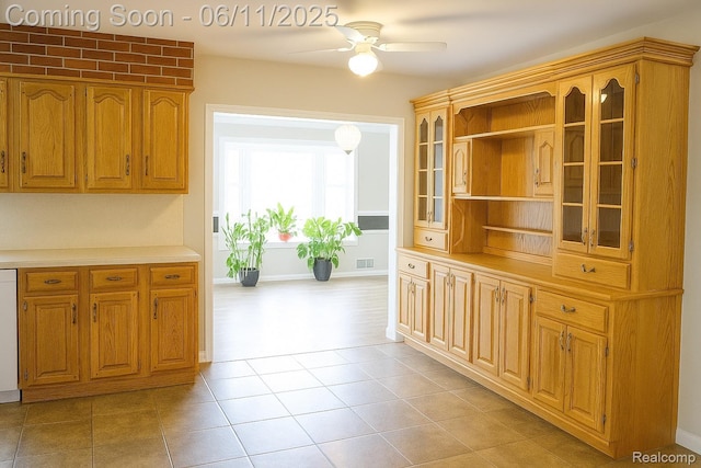 3161 Eastgate St, Burton, MI 48519 - kitchen with a ceiling fan, glass insert cabinets, light countertops, open shelves, and brown cabinets