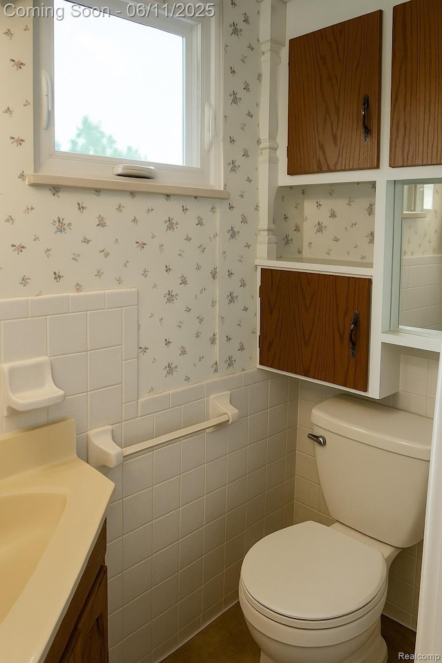 3161 Eastgate St, Burton, MI 48519 - half bath with wallpapered walls, tile walls, vanity, wainscoting, and toilet