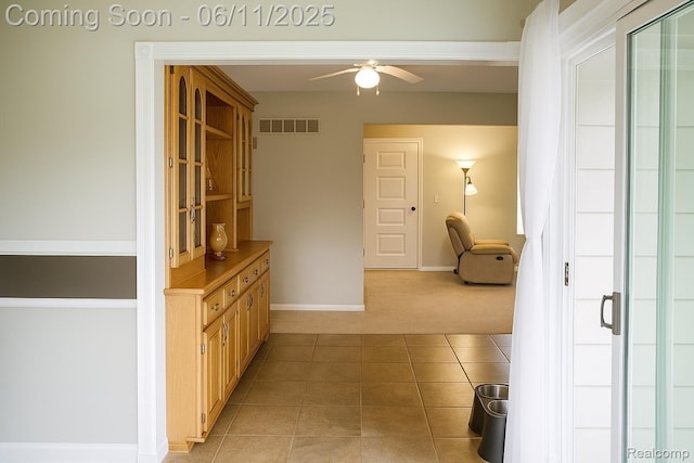 3161 Eastgate St, Burton, MI 48519 - hallway featuring light carpet, baseboards, and light tile patterned floors