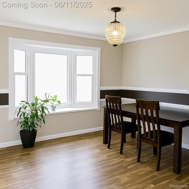 3161 Eastgate St, Burton, MI 48519 - dining room with wood finished floors, crown molding, baseboards, and a chandelier