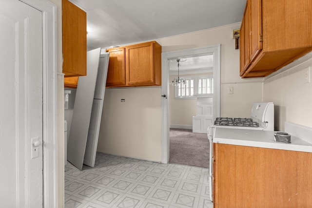 11414 Manor, Detroit, MI 48204 - kitchen with gas range gas stove, brown cabinets, light countertops, light flooring, and a chandelier
