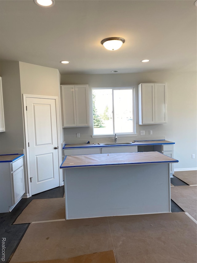 33548 Baldwin St, Farmington Hills, MI 48336 - kitchen featuring white cabinets, a kitchen island, light countertops, and recessed lighting