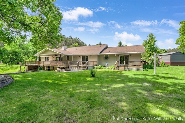 376 Stauffer Dr, Hastings, MI 49058 - back of house featuring a deck, ceiling fan, a lawn, and a chimney