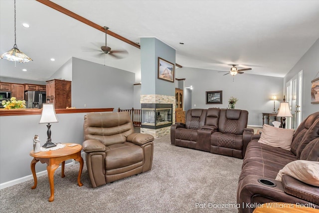 376 Stauffer Dr, Hastings, MI 49058 - living area with ceiling fan, carpet floors, lofted ceiling, a tile fireplace, and baseboards