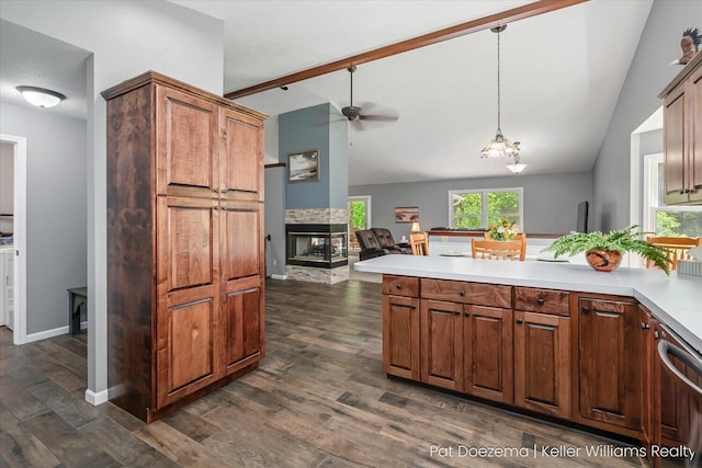 376 Stauffer Dr, Hastings, MI 49058 - kitchen with vaulted ceiling, ceiling fan, a peninsula, a multi sided fireplace, and dark wood finished floors