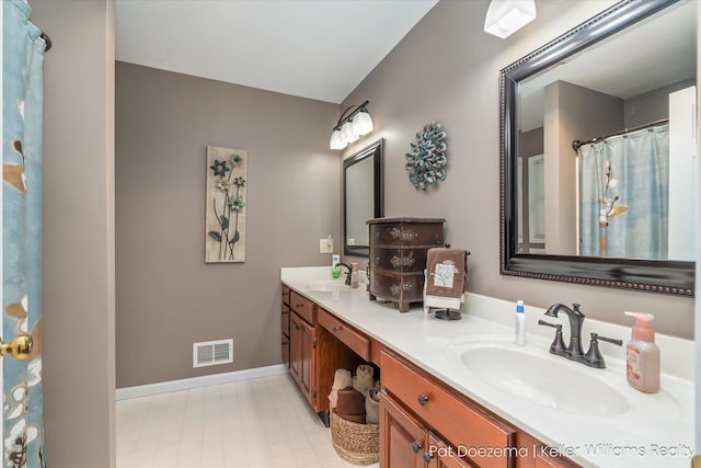 376 Stauffer Dr, Hastings, MI 49058 - full bathroom featuring double vanity and baseboards