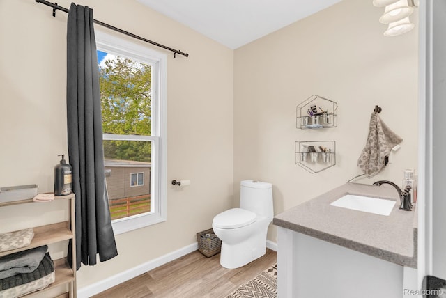 5668 Mill St, Peck, MI 48466 - half bathroom with wood finished floors, toilet, healthy amount of natural light, and baseboards