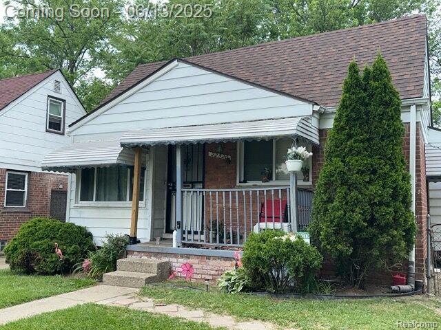 22520 Lyndon St, Detroit, MI 48223 - bungalow with covered porch, a shingled roof, and brick siding