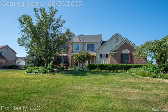 4233 Holly Ln, Rochester, MI 48306 - traditional-style house with a front yard, board and batten siding, and brick siding