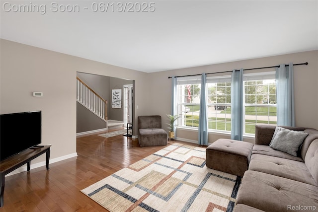 18885 English Ivy Dr, Macomb, MI 48042 - living area featuring stairs, wood finished floors, and baseboards