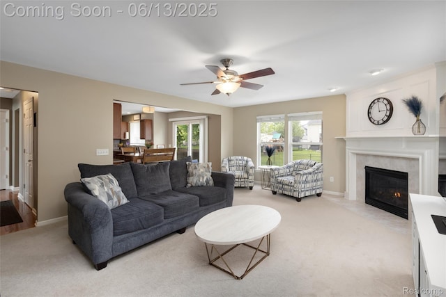 18885 English Ivy Dr, Macomb, MI 48042 - living area featuring ceiling fan, light carpet, a fireplace, and baseboards
