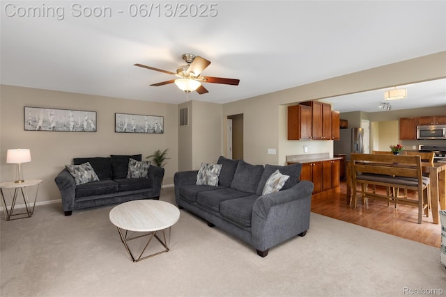 18885 English Ivy Dr, Macomb, MI 48042 - living room with light colored carpet, baseboards, and ceiling fan