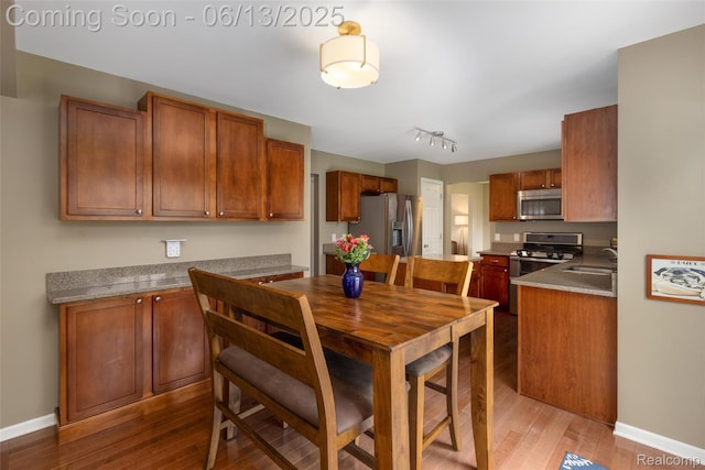 18885 English Ivy Dr, Macomb, MI 48042 - dining space with wood finished floors, baseboards, and track lighting