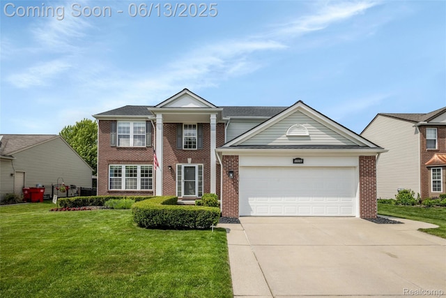 18885 English Ivy Dr, Macomb, MI 48042 - greek revival inspired property featuring brick siding, concrete driveway, a front lawn, and a garage