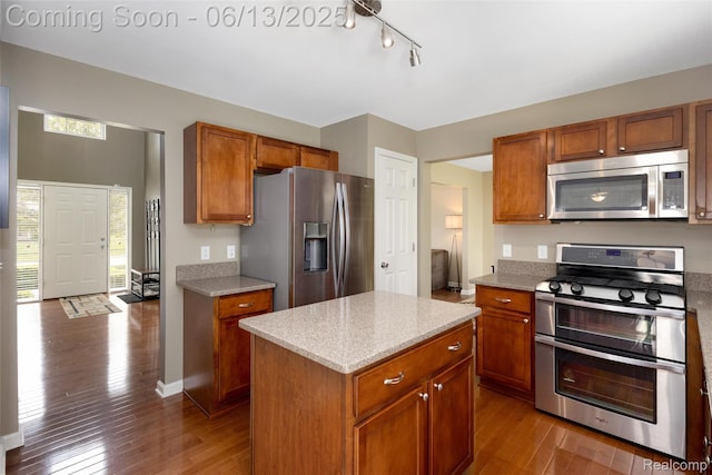 18885 English Ivy Dr, Macomb, MI 48042 - kitchen with appliances with stainless steel finishes, wood-type flooring, and brown cabinets