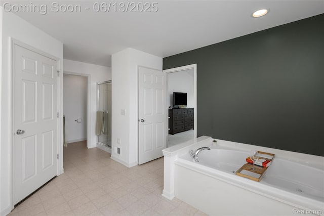18885 English Ivy Dr, Macomb, MI 48042 - full bath featuring a bath, a stall shower, baseboards, and recessed lighting