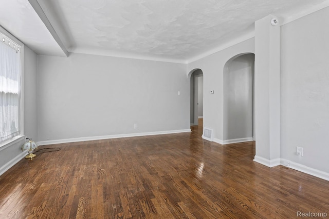 337 Burroughs Ave, Flint, MI 48507 - unfurnished room with arched walkways, wood finished floors, baseboards, and a smoke detector