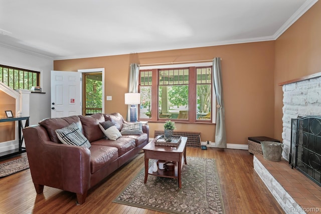 819 N Ball St, Owosso, MI 48867 - living area featuring a fireplace, wood finished floors, plenty of natural light, crown molding, and baseboards